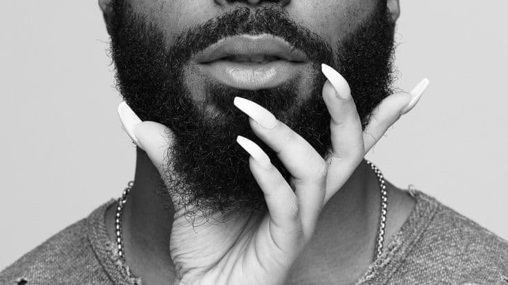 A woman holding a Man's Beard - Soft Launch Season